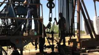 Oil field pulling unit wrenching rods [upl. by Haimerej]