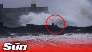 Storm Bella  Moment thrillseekers climb onto ROCKS to watch huge waves crash into South Wales coast [upl. by Aniar]