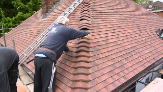 Reroofing my your house Cementing the bonnet tiles wwwgarecoukroof [upl. by Leuqim]