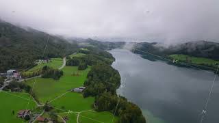 Low clouds drift across the landscape partially unveiling mountains and Fuschlsee in Austria on a [upl. by Balmuth499]