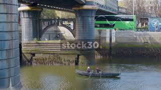 Two Old Men Rowing Boat Slowly Down The River Liffey Dublin Ireland [upl. by Gussman377]