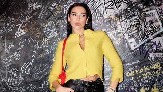 Dua Lipas cheeky leather hotpants sheer tights and lemonyellow cardigan combo is a thing of dreams [upl. by Antony290]