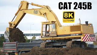 Cat 245B Loading Trucks 8K [upl. by Lumpkin492]