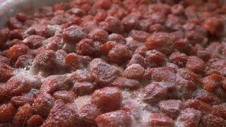 Large pot of strawberries boils releasing steam and creating bubbles [upl. by Janka]