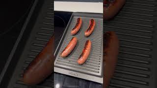 Grilling sausages in our Poggenpohl kitchen with the Miele induction cooktop and grille pan [upl. by Ellahcim]