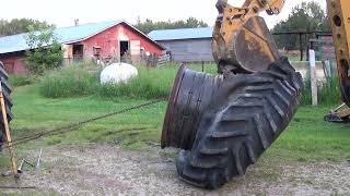 Case IH 7120 tractor changing a rear tire epic tug of war backhoe vs tire part 2 [upl. by Rambort300]