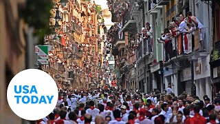 Thousands gather in Pamplona Spain for running of the bulls festival  USA TODAY [upl. by Oman607]