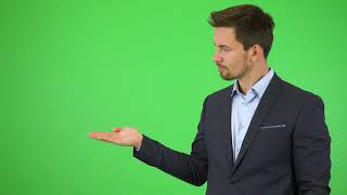 Green Screen  Chroma Key  A young handsome businessman puts out a hand with a product  4K  HD [upl. by Nairrod]