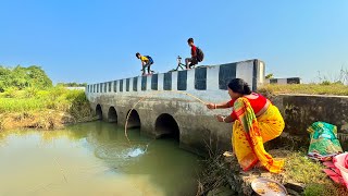 Fishing Video  A woman fisherman sits in a large canal and catches fish with a fishing rod  hook [upl. by Tindall]