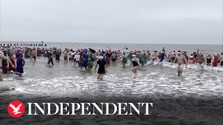 Swimmers run into cold Suffolk sea for Christmas swim [upl. by Ellehsyt210]