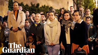 Parisians gather outside burning Notre Dame to sing hymns [upl. by Oguh]