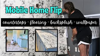 MOBILE HOME FLIP WEEK 2  BACKSPLASH  NEW COUNTERTOPS  FLOORING  LIGHT FIXTURES  WALLPAPER [upl. by Iphagenia]