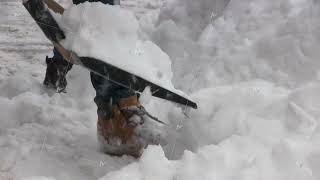 Snow piles cover streets as people work with shovels [upl. by Garold]