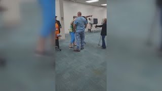 VIDEO  Fight breaks out after Trump supporter clashes with poll worker over MAGA hat dispute [upl. by Ayo]