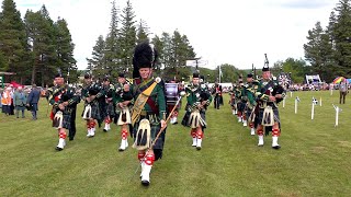 Drum Major leads Huntly Pipe Band playing on the march during Tomintoul Highland Games in Scotland [upl. by Eram486]