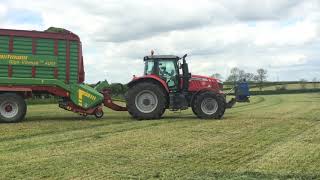 Massey Ferguson 7626 filling a Strautman forage wagon and Massey Ferguson 5480 with twin rotor rake [upl. by Atinuj]