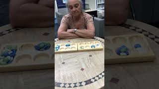 Playing Mancala boardgame [upl. by Aldarcie]