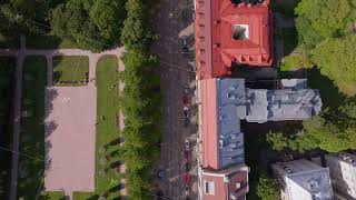 Aerial view moving forward over a street and a park in Helsinki Finland Cars are driving and [upl. by Enajaras]