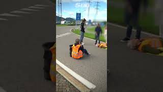 Eco protester knocked to the floor by car at protest [upl. by Hollinger]