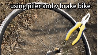 how to true a wheel without truing stand and special tools with just using v brake bike and piller [upl. by Ellevehc]