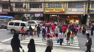 Street view with people walking in the Philippines [upl. by Oirevlis]