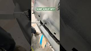 Laying seam sealer on this BMW after replacing the rear body panel seamsealer autobody collision [upl. by Rollet]