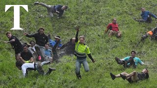 Daredevils chase cheese down steep hill in annual competition [upl. by Wilinski842]