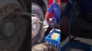 The process of unscrewing the nuts of a truck wheel with a powerful tool [upl. by Etiuqram717]