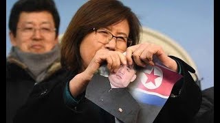 North Korean defectors tear up pictures of Kim Jong un in defiant Winter Olympics protest [upl. by Mairem]