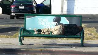 Homeless Man Sleeping on Bus Bench Los Angeles California USA October 14 2024 [upl. by Duncan]