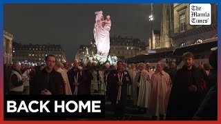 Candle procession returns Virgin Mary statue to rebuilt NotreDame Cathedral [upl. by Gnilrets509]