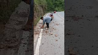 A good motorcycle man stops and clean the road from stones Heroes of humanity 🙏 viral humanity [upl. by Violetta]