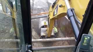 Cat 330d digging and laying 60quot concrete drain pipe [upl. by Arykat123]