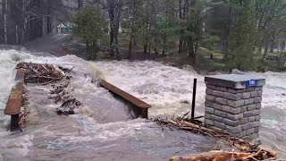 Swollen river swallows bridge in Maine as flash flooding warned [upl. by Aneeroc]