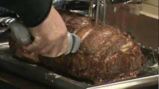 Slicing prime rib roast after grilling on the Rib Pro Charcoal Rotisserie Grill [upl. by Ahsinahs]