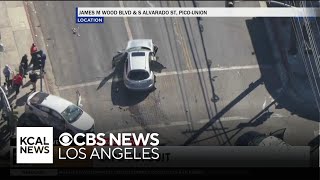 Robbery pursuit suspect crashes into another vehicle at a South Los Angeles intersection flees on f [upl. by Filippa]