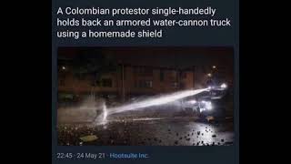 Colombian protestor single handedly holds back an armored watercannon truck using a homemade shield [upl. by Paehpos]