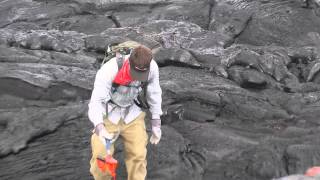 Geologist collects a fresh lava sample in Hawaii in May 2014 [upl. by Sollars]