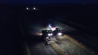 Drone video of Combining at night with John Deere S690 combines [upl. by Harad654]