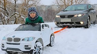 FUNNY BABY Stuck in the SNOW Kid ride on POWER WHEEL Towing car BMW Funny cars video for kids [upl. by Killoran]