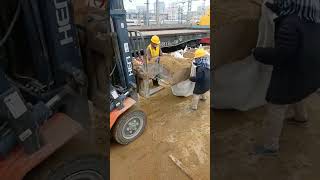 A forklift loads sand into a bag [upl. by Hairabez99]