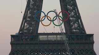 Olympic rings unveiled on Eiffel Tower for Paris 2024  AFP [upl. by Courtnay624]