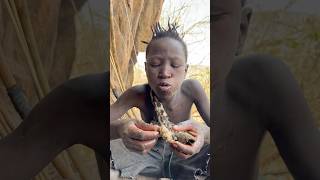 Hadzabe little boy enjoying his breakfast food hadzabetribe villagelife [upl. by Ahseina]