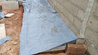 Installing damp proof membrane before pouring concrete slab for shed — Building in Ghana [upl. by Kinna]