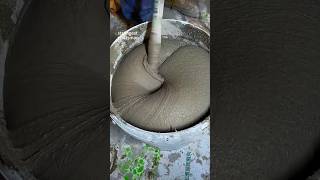 Construction worker mixing plaster coating with mixer [upl. by Jonati]