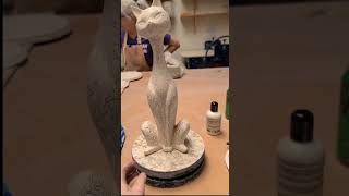 Artist is drawing a freehand pattern onto a ceramic cat and painting the spots [upl. by Vasquez]