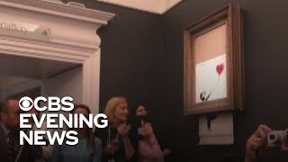 Banksy painting self destructs after 14 million sale [upl. by Akemehc406]