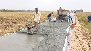 Construction A Concrete Road Stretching On Rural Fields With ReadyMixed Concrete [upl. by Anecusa]