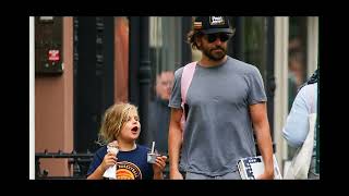 Bradley Cooper is a doting dad as he stops to tie 7yearold daughter Leas shoelace during New York [upl. by Annahgiel]