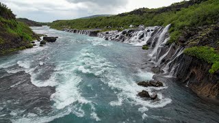 Flying in the rain at Hraunfossar Barnafoss Waterfalls in Iceland [upl. by Mcnalley]